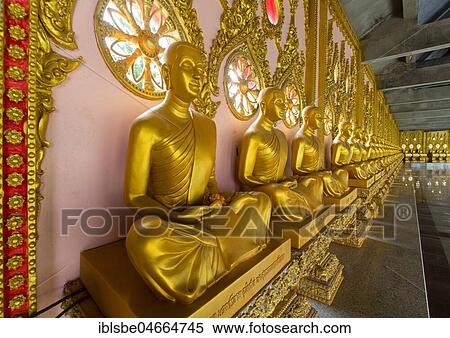 Row of golden Buddha statues in the corridor of the Phra Maha Chedi Chai Mongkhon Pagoda, Wat Pha Nam Yoi Temple, Phuttha-Utthayan Park, Province Roi Et, Isan, Northeast, Thailand, Asia View Large Photo Image Stock Photography - Row of golden Buddha statues in the corridor of the Phra Maha Chedi Chai Mongkhon Pagoda, Wat Pha Nam Yoi Temple, Phuttha-Utthayan Park, Province Roi Et, Isan, Northeast, Thailand, Asia. Fotosearch