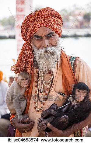 Sadhu with monkeys in his arm, while Hindu festival Kumbh Mela, Ujjain, India, Asia View Large Photo Image Picture - Sadhu with monkeys in his arm, while Hindu festival Kumbh Mela, Ujjain, India, Asia. Fotosearch