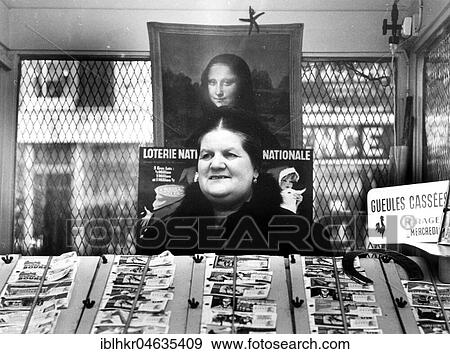 Stock Photo - Saleswoman looks like the aged Mona Lisa, 50's to 60's, exact place unknown, France, Europe. Fotosearch