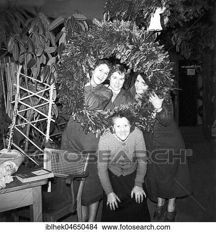 Saleswomen of a flower shop posing in front of a large Advent wreath, 1960s, Germany, Europe View Large Photo Image Picture - Saleswomen of a flower shop posing in front of a large Advent wreath, 1960s, Germany, Europe. Fotosearch