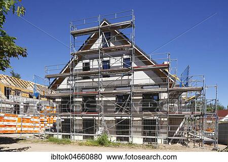 Scaffolded house, construction site, building shell, Malente, Schleswig-Holstein, Germany, Europe View Large Photo Image Stock Image - Scaffolded house, construction site, building shell, Malente, Schleswig-Holstein, Germany, Europe. Fotosearch