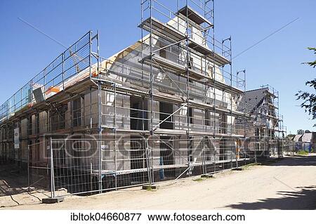 Scaffolded house, construction site, building shell, Malente, Schleswig-Holstein, Germany, Europe View Large Photo Image Stock Photo - Scaffolded house, construction site, building shell, Malente, Schleswig-Holstein, Germany, Europe. Fotosearch