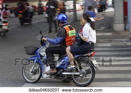 Scooter Taxi, driver with safety vest drives young girl, Sathon, Bangkok, Thailand, Asia View Large Photo Image Stock Photo - Scooter Taxi, driver with safety vest drives young girl, Sathon, Bangkok, Thailand, Asia. Fotosearch