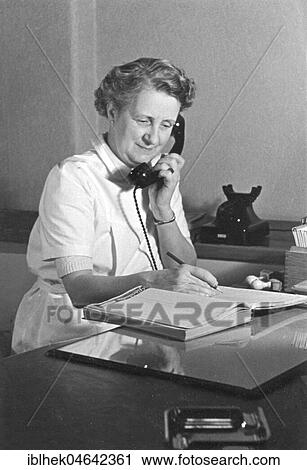 Stock Image - Secretary, woman on the phone, 1960s, Germany, Europe. Fotosearch