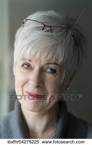Stock Photography - Seniorin mit grauem Haar und Brille auf der Stirn lachelt, Portrait, Deutschland, Europa. Fotosearch