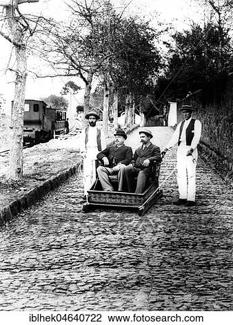 Stock Image - Service, two tourists are transported down a slope, 1910s, exact location unknown, Portugal, Europe. Fotosearch