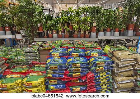 Stock Image - Shelf with potting soil, garden centre, interior, Bavaria, Germany, Europe. Fotosearch