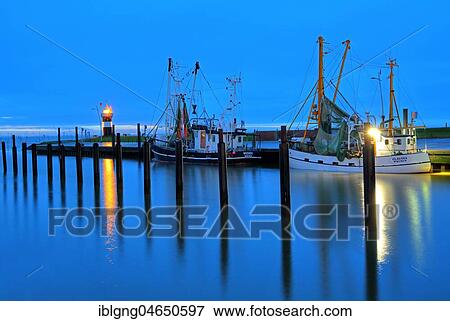 Stock Photo - Shrimp Cutter Harbour and Lighthouse Kleiner Preusse with Christmas Tree, Wremen, Land Wursten, Weser estuary, North Sea coast, Lower Saxony, Germany, Europe. Fotosearch