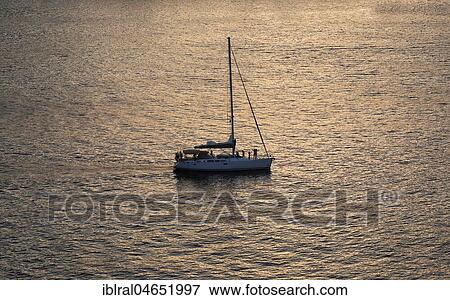 Silhouette of a sailboat in the Mediterranean Sea, coast off Ajacchio, Corsica, France, Europe View Large Photo Image Stock Photo - Silhouette of a sailboat in the Mediterranean Sea, coast off Ajacchio, Corsica, France, Europe. Fotosearch