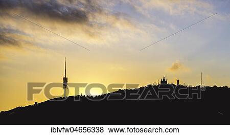 Stock Photo - Silhouette with TV tower Torre de Collserola, Collserola tower, Church Sagrat Cor, Tibidabo theme park, backlight at sunset on Tibidabo hill, Barcelona, Catalonia, Spain, Europe. Fotosearch