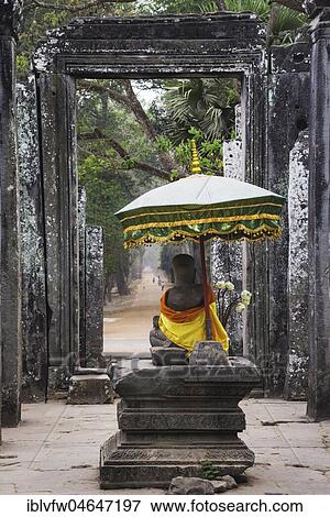Stock Photo - Sitting Buddha in front of Bayon Temple, Angkor Thom Complex, Angkor Archaeological Park, Siem Reap Province, Cambodia, Asia. Fotosearch