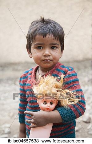 Small child with doll in the slum at the Ghazipur garbage dump, New Delhi, India, Asia View Large Photo Image Stock Photo - Small child with doll in the slum at the Ghazipur garbage dump, New Delhi, India, Asia. Fotosearch