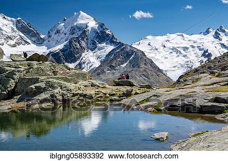 Stock Image - Small mountain lake on Fuorcla Surlej with Piz Roseg and Piz Glüschaint, Silvaplana, Bernina Alps, Upper Engadine, Engadine, Grisons, Switzerland, Europe. Fotosearch