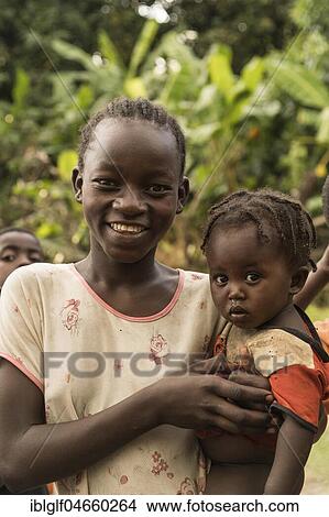 Smiling girl holding toddler in her arms, portrait, Ari tribe, Southern Nations Nationalities and Peoples' Region, Ethiopia, Africa View Large Photo Image Picture - Smiling girl holding toddler in her arms, portrait, Ari tribe, Southern Nations Nationalities and Peoples' Region, Ethiopia, Africa. Fotosearch