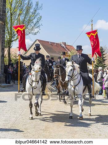 Stock Image - Sorbian men riding on decorated horses, traditional Easter riding on Easter Sunday, Radibor, Saxony, Germany, Europe. Fotosearch