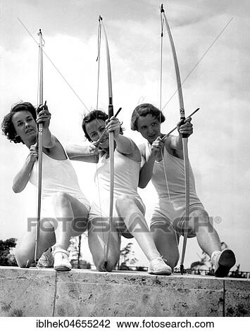Stock Image - Sport, three women doing archery, 1940s, exact location unknown, Germany, Europe. Fotosearch