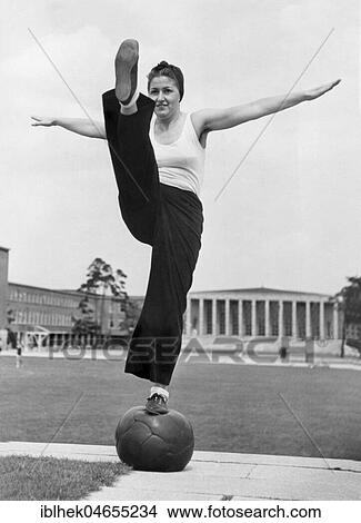 Sport, woman balancing on a medicine ball, 1930s, exact place unknown, Germany, Europe View Large Photo Image Picture - Sport, woman balancing on a medicine ball, 1930s, exact place unknown, Germany, Europe. Fotosearch