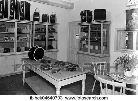 Stock Image - Suitcase in the salesroom with Hitler portrait on the wall, Nazi era, 1941, 1940s, exact location unknown, Germany, Europe. Fotosearch