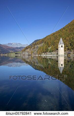 Stock Image - Sunken church tower in the reservoir at the Reschenpass, Graun, Vinschgau, South Tyrol, Italy, Europe. Fotosearch