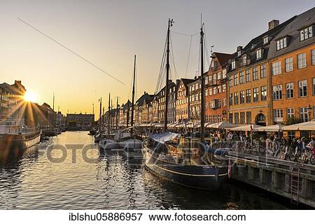 Sunset at the busy Nyhavn Canal, amusement district, Copenhagen, Denmark, Europe View Large Photo Image Stock Photo - Sunset at the busy Nyhavn Canal, amusement district, Copenhagen, Denmark, Europe. Fotosearch