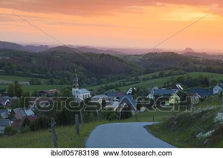 Stock Photo - Sunset in Saupsdorf with Lilienstein, Königstein and Schrammsteinen, National Park Saxon Switzerland, Saxony, Germany, Europe. Fotosearch