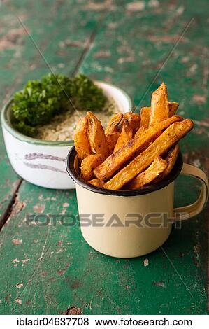 Stock Photo - Sweet potato chips, silllife, food, studio shot. Fotosearch