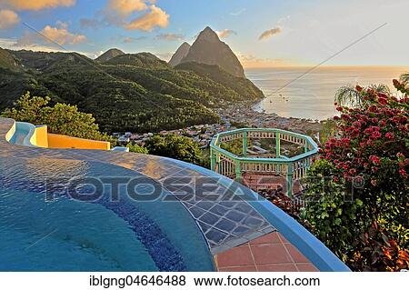 Stock Photo - Swimming pool of the La Haut Resort with view of the village and the two Pitons, Gros Piton 770m and Petit Piton 743m, evening sun, Soufriere, St. Lucia, Lesser Antilles, West Indian Islands, Caribbean Sea. Fotosearch