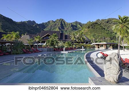 Picture - Swimming pool with mountainous landscape, green hills, luxury hotel, Interconti Resort, Moorea, company islands, Leeward Islands, Pacific Ocean, French Polynesia, Oceania. Fotosearch