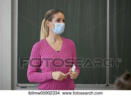 Picture - Teacher with face mask, Corona crisis, Baden-Württemberg, Germany, Europe. Fotosearch