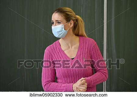 Stock Image - Teacher with face mask, Corona crisis, Baden-Württemberg, Germany, Europe. Fotosearch