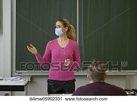 Stock Image - Teacher with face mask, Corona crisis, Baden-Württemberg, Germany, Europe. Fotosearch