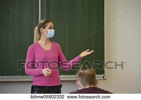 Stock Image - Teacher with face mask, Corona crisis, Baden-Württemberg, Germany, Europe. Fotosearch