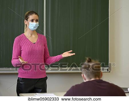 Stock Image - Teacher with face mask, Corona crisis, Baden-Württemberg, Germany, Europe. Fotosearch