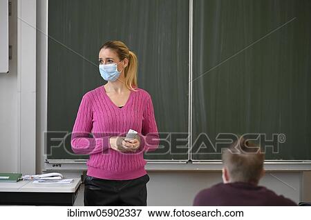 Stock Photo - Teacher with face mask, Corona crisis, Baden-Württemberg, Germany, Europe. Fotosearch