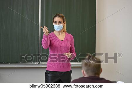 Stock Photo - Teacher with face mask, Corona crisis, Baden-Württemberg, Germany, Europe. Fotosearch