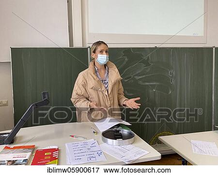 Teacher with thick winter jacket and face mask in classroom teaching, gestures, corona crisis, Stuttgart, Baden-Württemberg, Germany, Europe View Large Photo Image Stock Photo - Teacher with thick winter jacket and face mask in classroom teaching, gestures, corona crisis, Stuttgart, Baden-Württemberg, Germany, Europe. Fotosearch