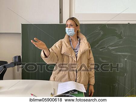 Teacher with thick winter jacket and face mask in classroom teaching, gestures, corona crisis, Stuttgart, Baden-Württemberg, Germany, Europe View Large Photo Image Stock Photo - Teacher with thick winter jacket and face mask in classroom teaching, gestures, corona crisis, Stuttgart, Baden-Württemberg, Germany, Europe. Fotosearch