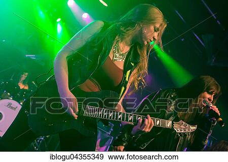 The American women's metal band The Iron Maidens, tribute band of the British heavy metal band Iron Maiden live in the Schüür Lucerne, Switzerland vocals Kirsten Rosenberg drumset Linda McDonald guitar Courtney Cox guitar Nita Strauss View Large Photo Image Stock Photo - The American women's metal band The Iron Maidens, tribute band of the British heavy metal band Iron Maiden live in the Schüür Lucerne, Switzerland vocals Kirsten Rosenberg drumset Linda McDonald guitar Courtney Cox guitar Nita Strauss. Fotosearch