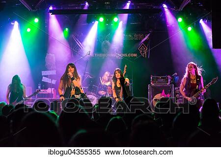 The American women's metal band The Iron Maidens, tribute band of the British heavy metal band Iron Maiden live in the Schüür Lucerne, Switzerland vocals Kirsten Rosenberg drumset Linda McDonald guitar Courtney Cox guitar Nita Strauss View Large Photo Image Stock Photography - The American women's metal band The Iron Maidens, tribute band of the British heavy metal band Iron Maiden live in the Schüür Lucerne, Switzerland vocals Kirsten Rosenberg drumset Linda McDonald guitar Courtney Cox guitar Nita Strauss. Fotosearch