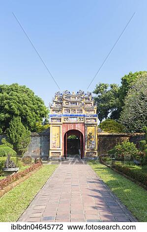 Stock Image - The decorative yellow gate leading to the Mieu temple inside the imperial citadel, Hue, Vietnam, Asia. Fotosearch