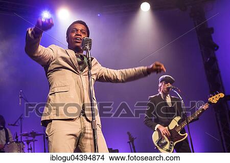 The US-American Rhythm and Blues Band Vintage Trouble live at the Blue Balls Festival Lucerne, Switzerland Ty Taylor: Vocals Nalle Colt: Guitar Rick Barrio Dill: Bass Richard Danielson: Drums View Large Photo Image Picture - The US-American Rhythm and Blues Band Vintage Trouble live at the Blue Balls Festival Lucerne, Switzerland Ty Taylor: Vocals Nalle Colt: Guitar Rick Barrio Dill: Bass Richard Danielson: Drums. Fotosearch