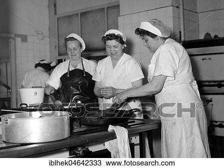 Stock Image - Three cooks in the kitchen, 1960s, Germany, Europe. Fotosearch