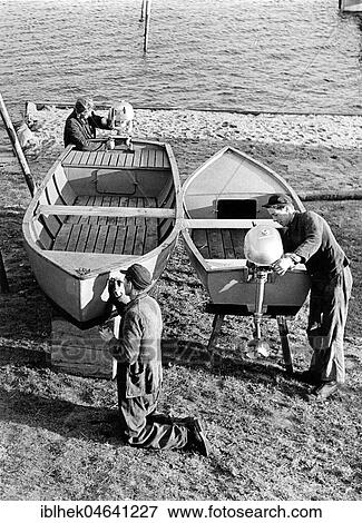Three men repairing a boat, 1960s, Baltic Sea, Germany, Europe View Large Photo Image Stock Photo - Three men repairing a boat, 1960s, Baltic Sea, Germany, Europe. Fotosearch