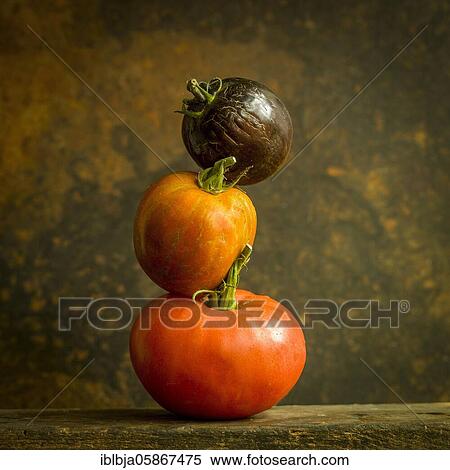 Stock Photography - Three tomatoes of various varieties, studio shot, France, Europe. Fotosearch