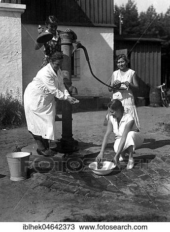 Three women fetching water from a pump, 1920s, Germany, Europe View Large Photo Image Stock Image - Three women fetching water from a pump, 1920s, Germany, Europe. Fotosearch