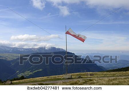 Stock Image - Tiroler Flagge weht auf der Raschotzer Alm, Raschotz bei St. Ulrich, hinten Puflatsch, Grodnertal, Sudtirol, Alto Adige, Italien, Europa. Fotosearch