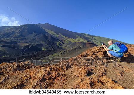 Tourist photographing, Volcanic landscape, Volcano Etna, Province of Catania, Silzilia, Italy, Europe View Large Photo Image Stock Photography - Tourist photographing, Volcanic landscape, Volcano Etna, Province of Catania, Silzilia, Italy, Europe. Fotosearch