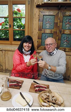 Stock Photo - Tourists at the Törggelen with fresh wine, man, woman, couple, South Tyrol, Italy, Europe. Fotosearch