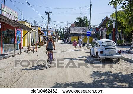 Stock Image - Tourists in a street of Isla Holbox, Quintana Roo, Mexico, Central America. Fotosearch