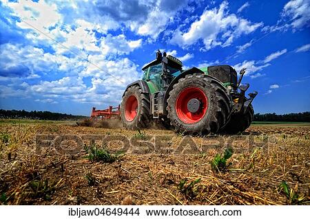 Tractor on harvested field, Germany, Europe View Large Photo Image Picture - Tractor on harvested field, Germany, Europe. Fotosearch
